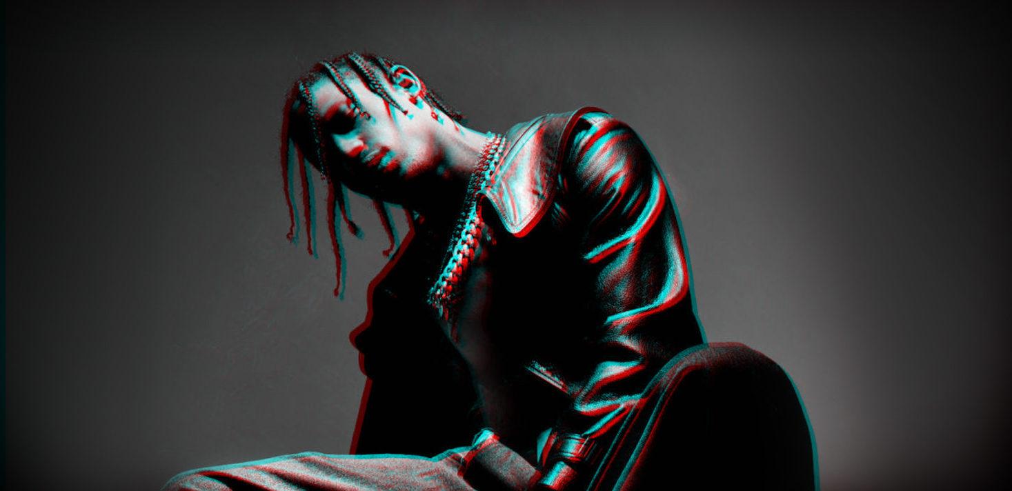 Travis Scott poseeraa istuaalteen nojaten taakse.