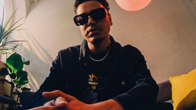Karim B istumassa aurinkolasit päässä.