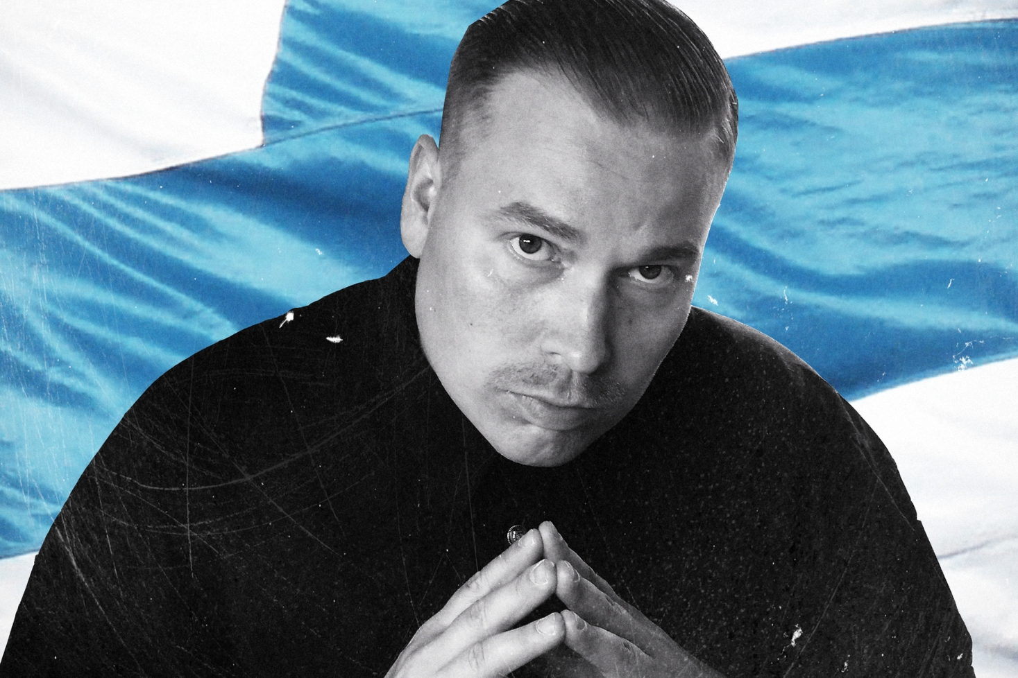 Heikki Kuula ja Suomen-lippu. Heikki Kuulan Isät-levy on keskiluokkaisen rehellinen ja tuore!